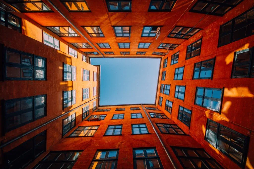 low angle shot of a unique high rise orange building touching the sky